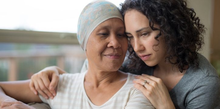 Young adult female hugging her mother who has Ovarian cancer