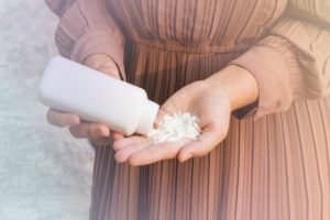 Woman applying talcum powder to her hand