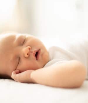 infant child sleeping on its back